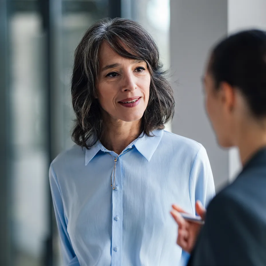 Two colleagues in an open, face-to-face conversation